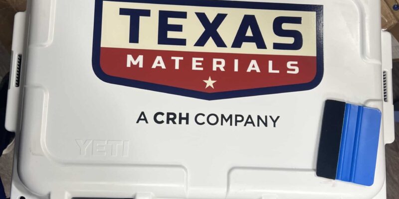 Custom UV transfer sticker and 3D embossed logo decal on a durable Yeti case professionally installed by our local print shop near me in Austin.