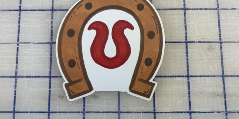 Custom die-cut horseshoe sticker and branded vinyl decal printed by our local print shop near me in Austin.