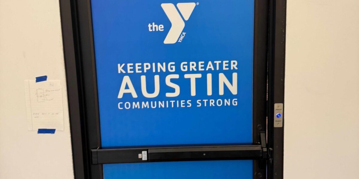 Custom vinyl window branding and storefront logo decals for an educational facility installed by our local print shop near me in Austin.