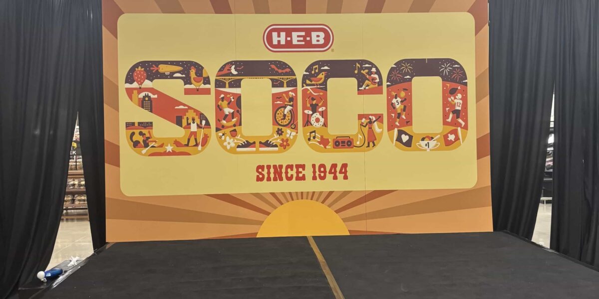 Custom step and repeat backdrop and branded media wall for a corporate event professionally installed by our local print shop near me in Austin.