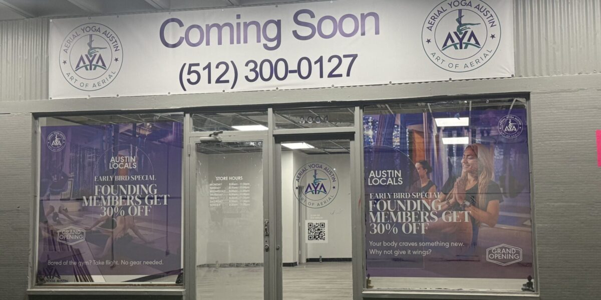 Full storefront signage package including custom vinyl banner and perforated window film by our Austin print shop near me.