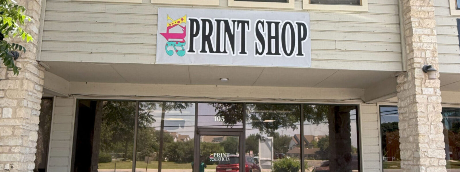 ATX Print Services storefront and local print shop near me in Austin featuring custom business signage and banners.