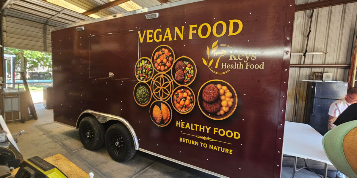 Custom food trailer vinyl wrap and commercial kitchen trailer graphics installed by our local print shop near me in Austin.