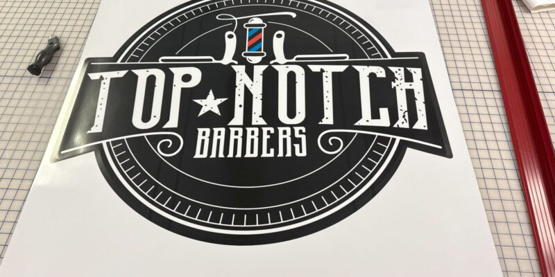 Custom die-cut decal and branded floor graphic for a barbershop produced by our local print shop near me in Austin.