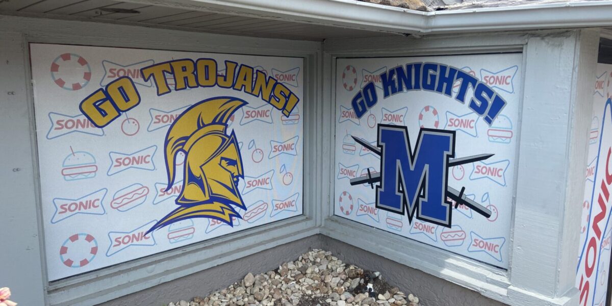 Custom one-way perforated window clings and vibrant business storefront graphics with professional installation by our local print shop near me in Austin.