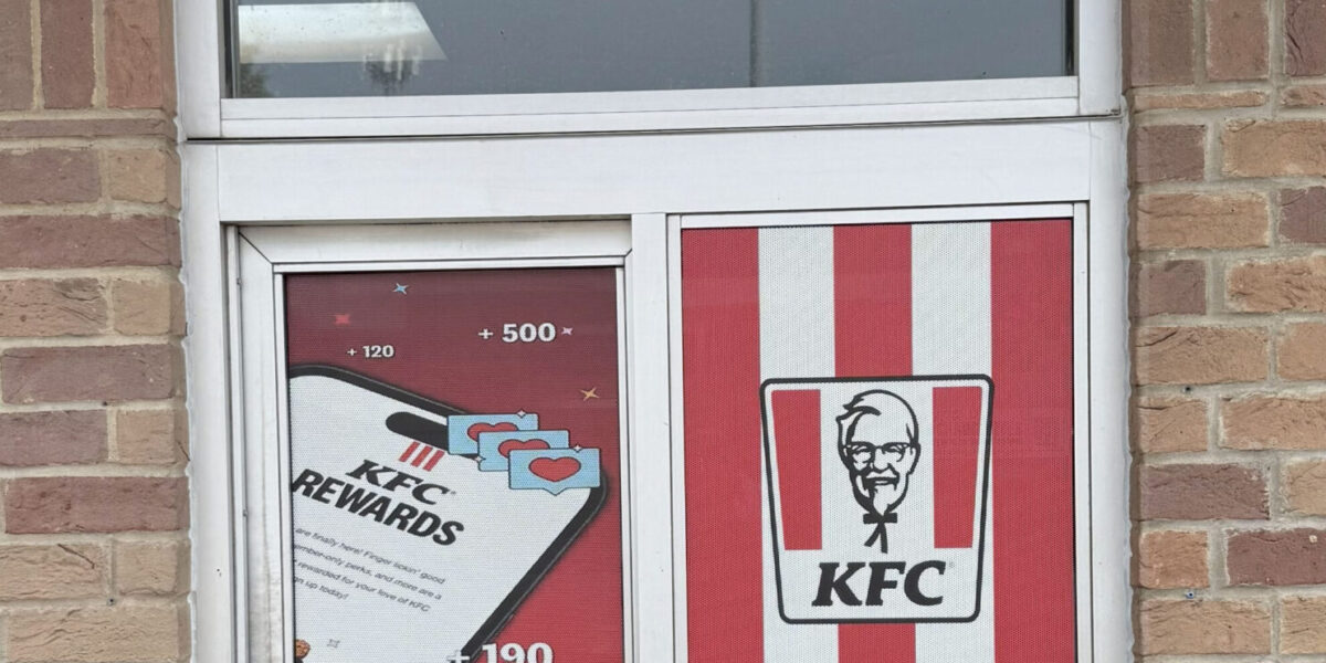 Custom perforated window film and one-way vision storefront graphics installed by our local print shop near me in Austin.